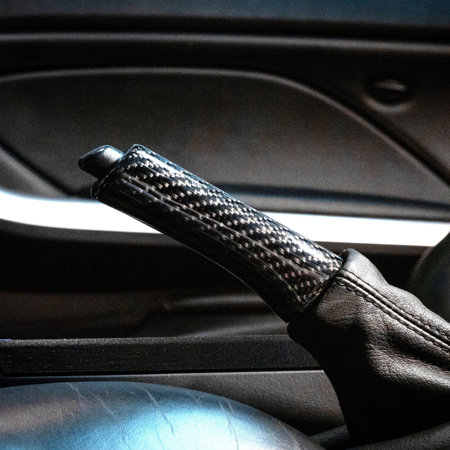 Close-up of carbon fiber parking brake handle in E46