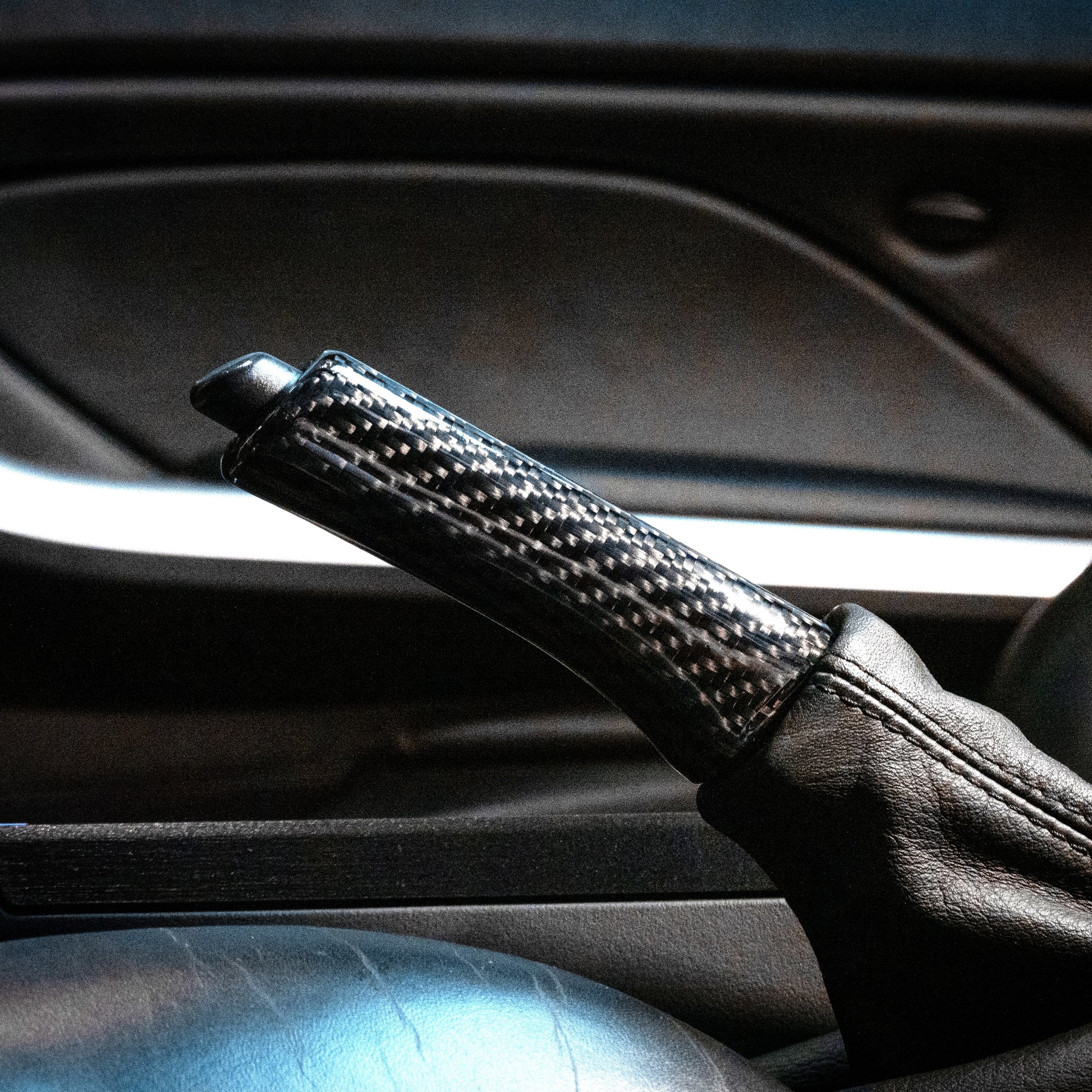 Close-up of carbon fiber parking brake handle in E46