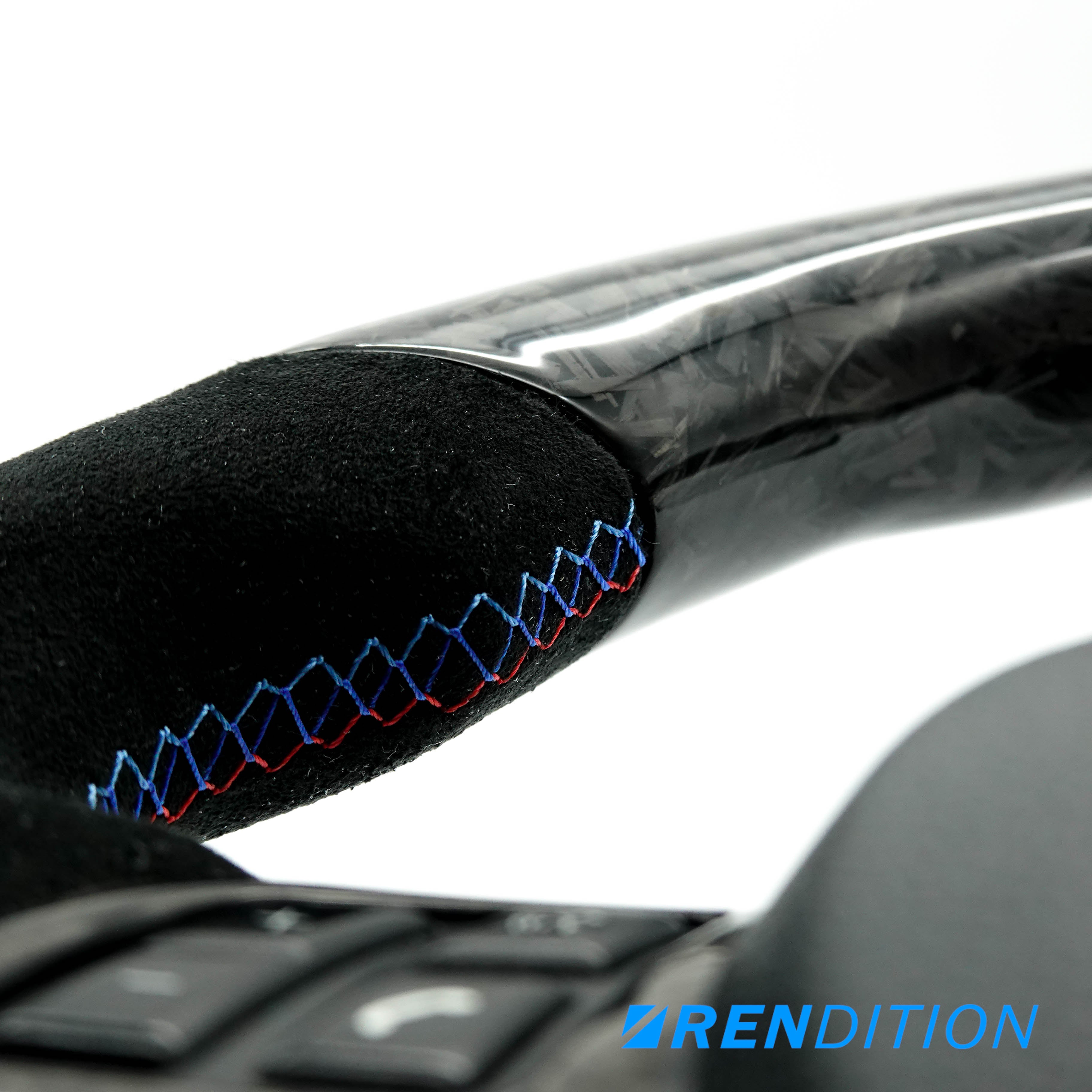 Custom BMW steering wheel in forged carbon, Alcantara, and gloss finish