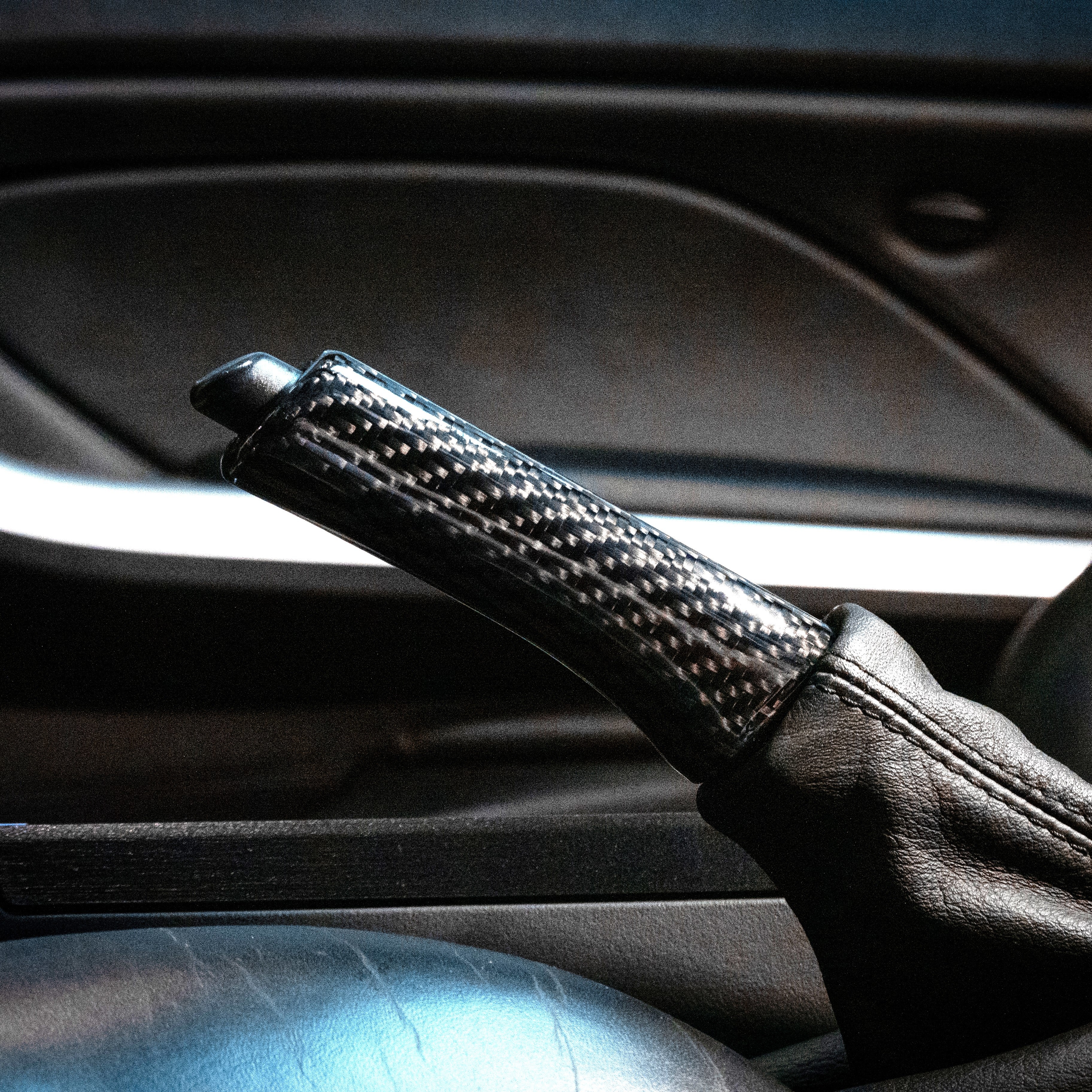 Close-up of carbon fiber parking brake handle in E46